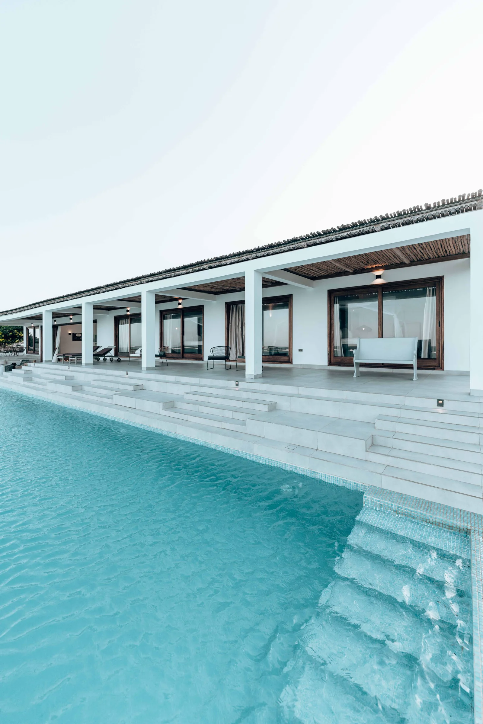 Architectural pool aligned with a modern residence